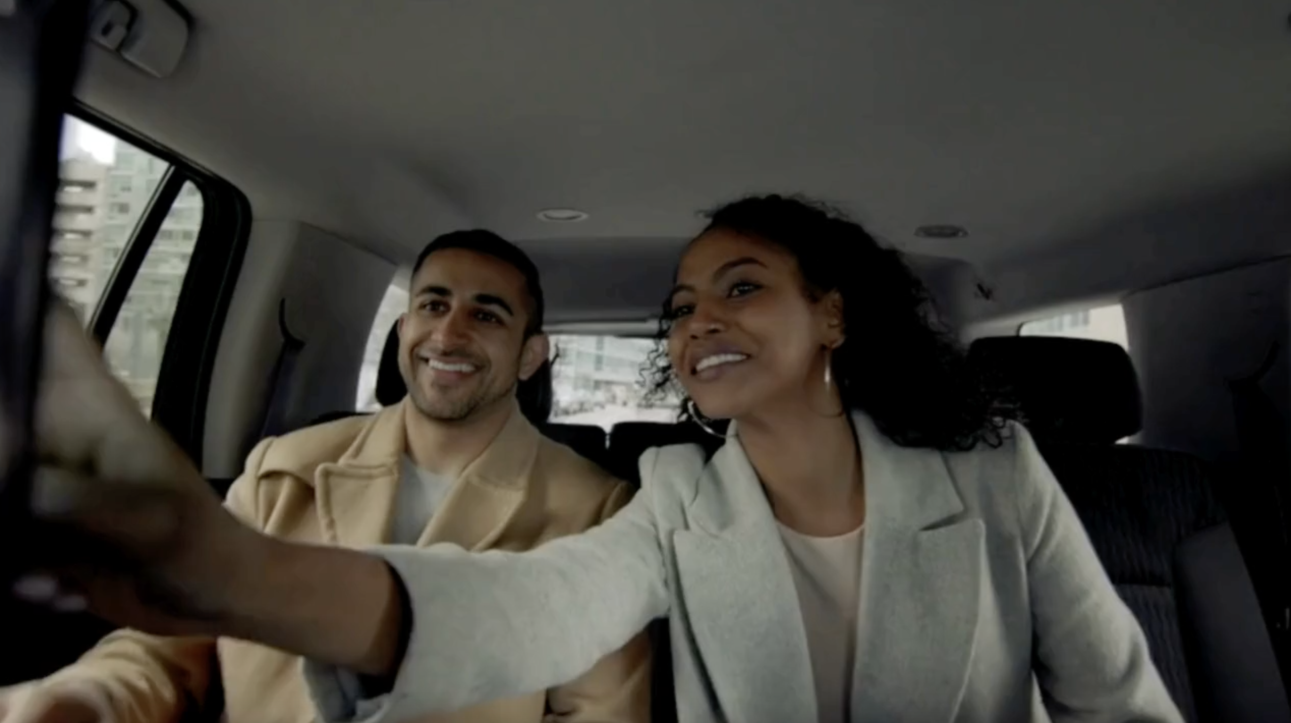 Passengers riding in the back seat of a vehicle