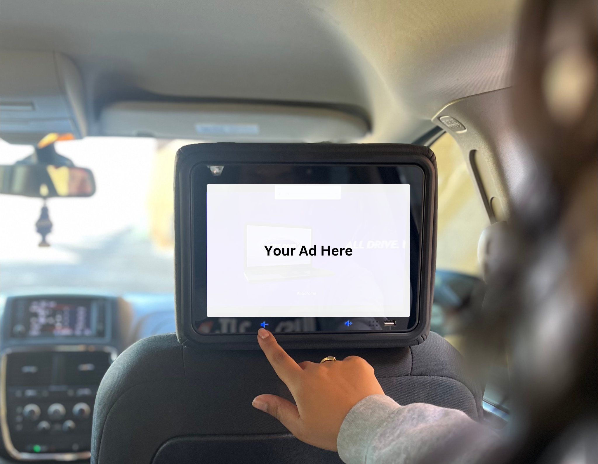A Vugo in-vehicle screen showing Your Ad Here creative